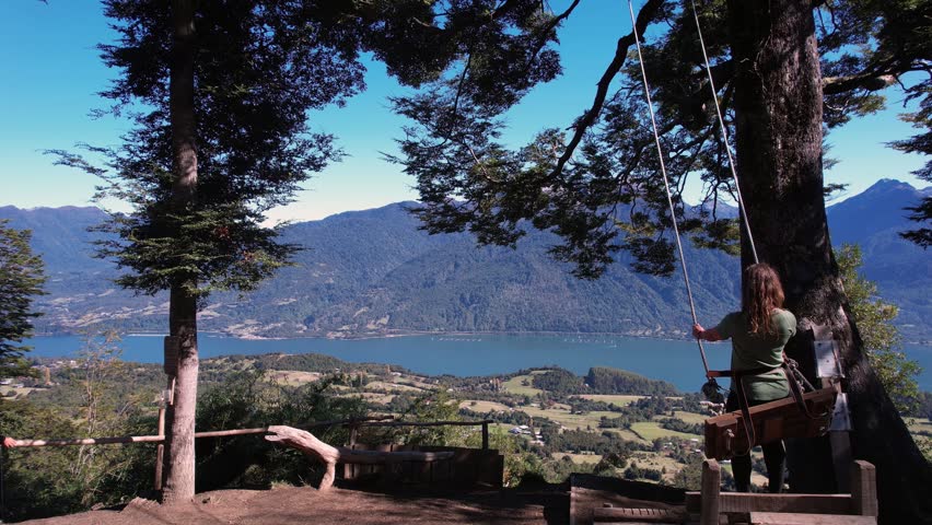 Drone View Over Cochamo Landscape And Woman Swinging Back And Forth, Chile 
