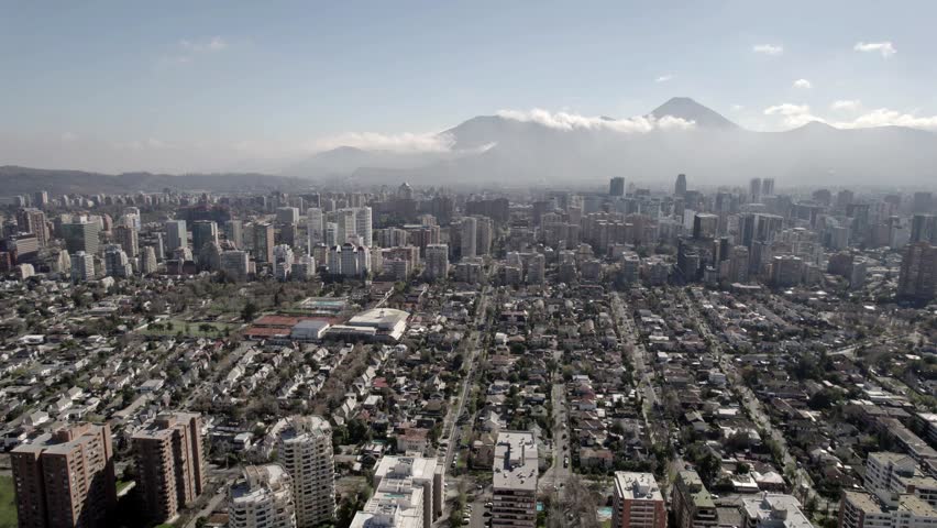 Cinematic Drone Ascending View Of Santiago Cityscape And Mountain Horizon