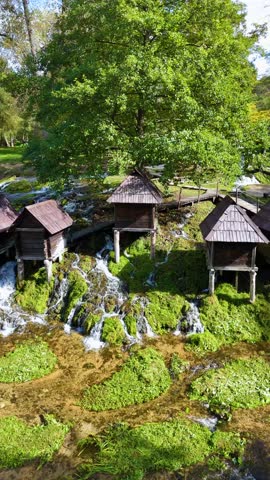 Small traditional wooden watermills of mlincici at pliva lakes near jajce. Beautiful natural landscape with waterfalls in bosnia and herzegovina