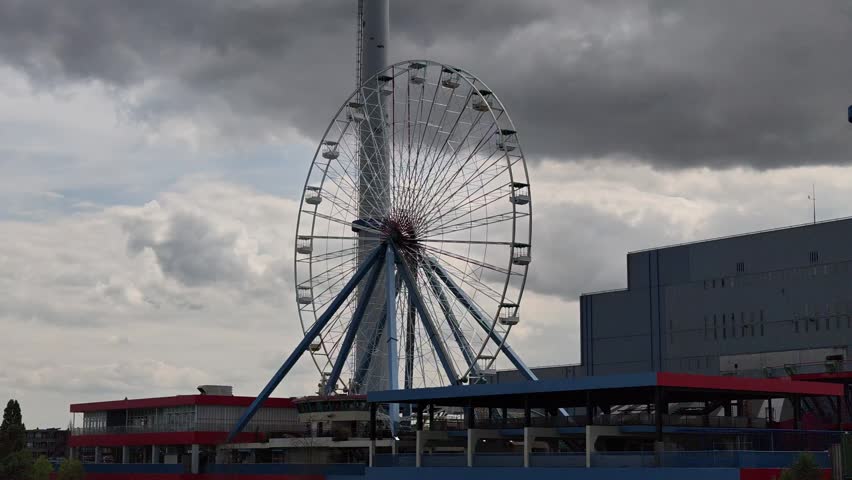 Dolly View Passing Ferris Wheel on Waterfront in Rotterdam
