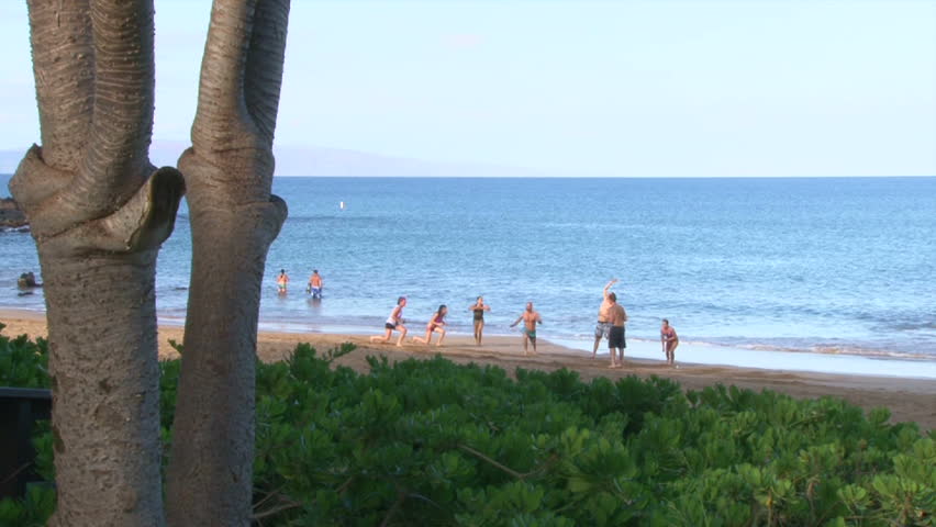 MAUI, HAWAII - CIRCA 2013: Group of men and women cross fit exercising on sandy