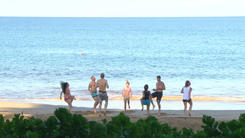 MAUI, HAWAII - CIRCA 2013: Group of men and women cross fit exercising on sandy