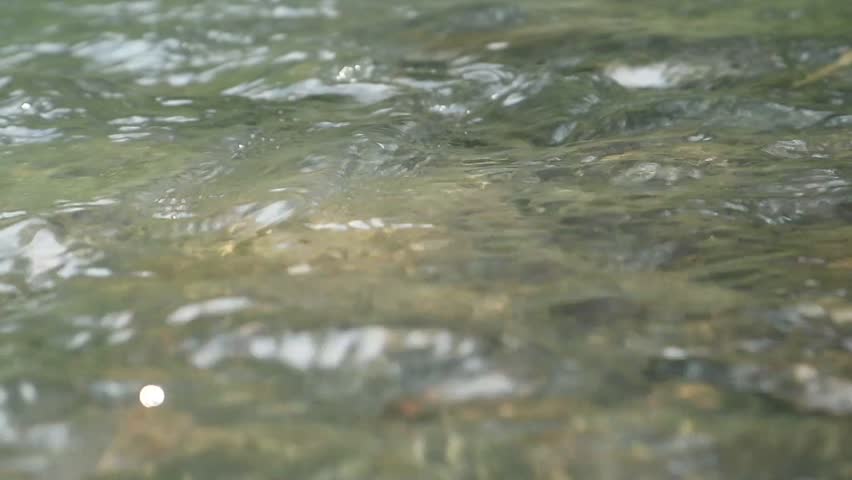 Details and texture of river water movement at moderate speed