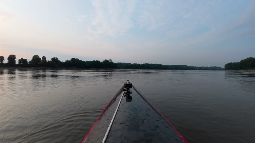 sunrise paddling on the Missouri River near Mokane, MO - immersive POV from racing kayak or canoe