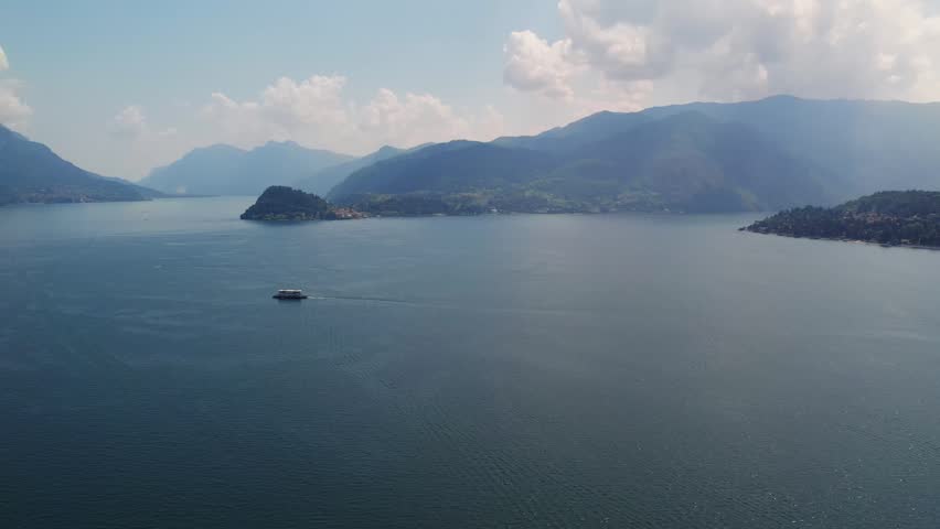 Wide aerial view of Lake Como surrounded by mountains