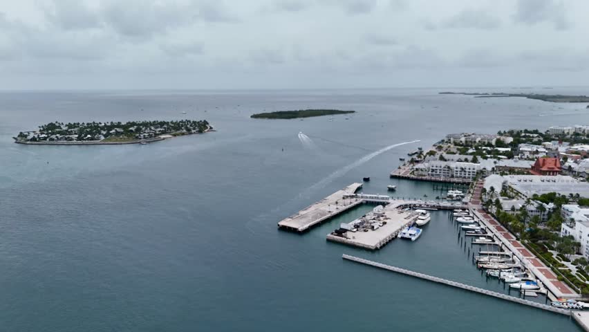 Key West, Florida, USA - view from airplane of waterfront, harbor, park, and ocean with a ship docked along the coast. g.