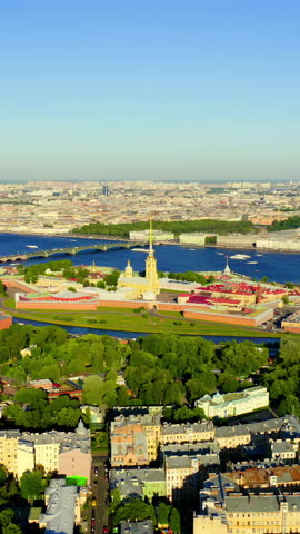 Vertical video. Saint-Petersburg, Russia. The Peter and Paul Fortress stands on Hare Island at the confluence of the Neva River, its golden spire rising above the star-shaped bastion walls that have defined the city