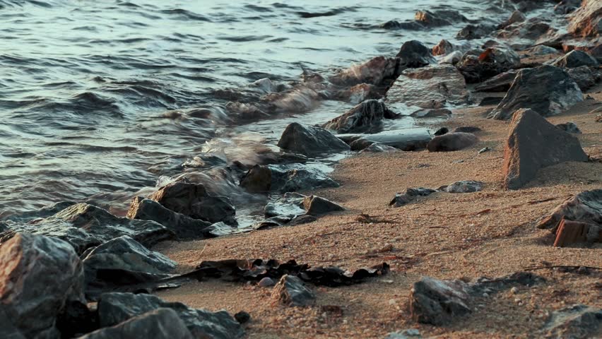 Sea Waves Washing Over Rocky Coastal Shore  