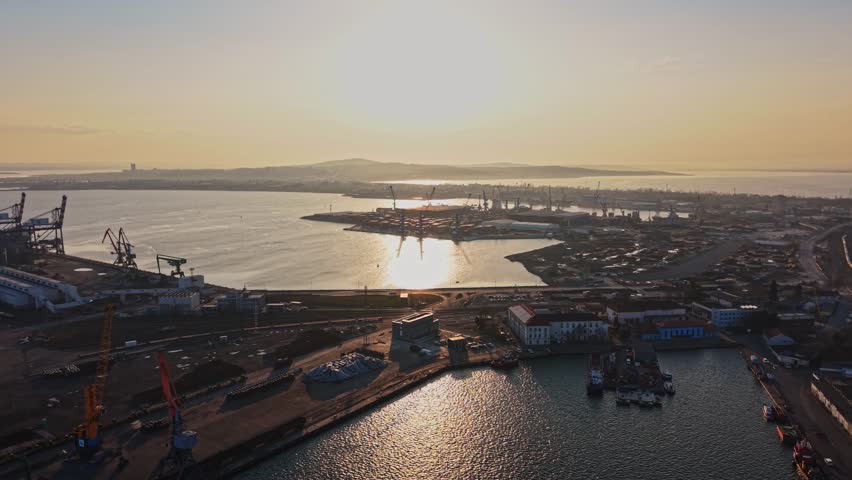 Wide angle aerial shot of the port bay featuring container ships and storage areas.