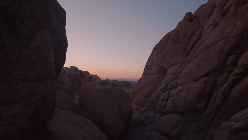 Tracking shot at dusk amidst the rock formations in Joshua Tree National Park