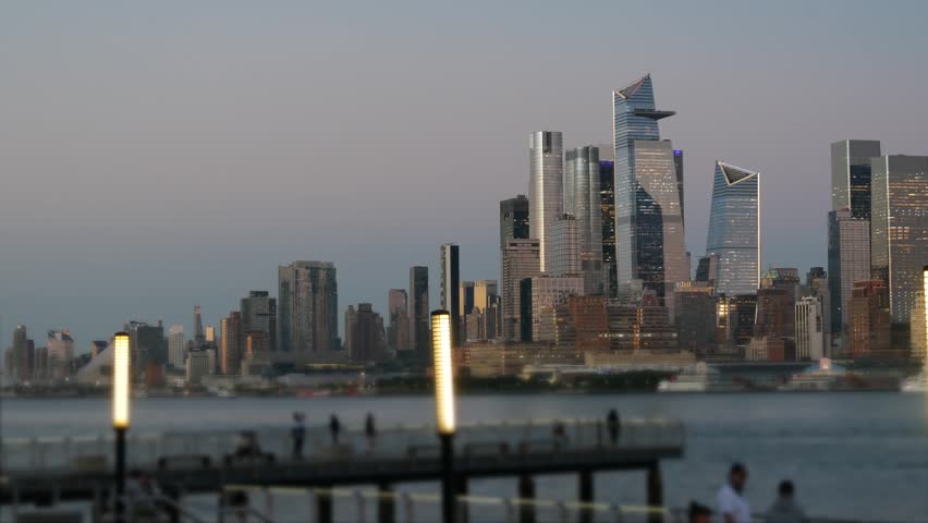 New York City Manhattan Midtown skyline, Chelsea and Hudson Yards towers from New Jersey, Hoboken pier, United States. River waterfront urban cityscape with skyscraper buildings, Evening dusk twilight