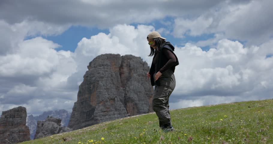 A woman enjoying the scenic landscape at Cinque Torri near Cortina d