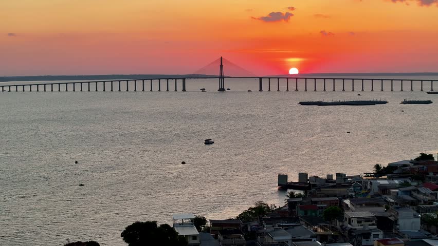 Manaus Skyline At Manaus In Amazonas Brazil. Sunrise Cable Bridge. Peaceful Landscape. Amazon Black River. Manaus Skyline In Manaus In Amazonas Brazil. Beautiful Sunset. Amazon Forest.