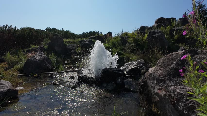 Small Waterfall Flowing Through Rocky Landscape