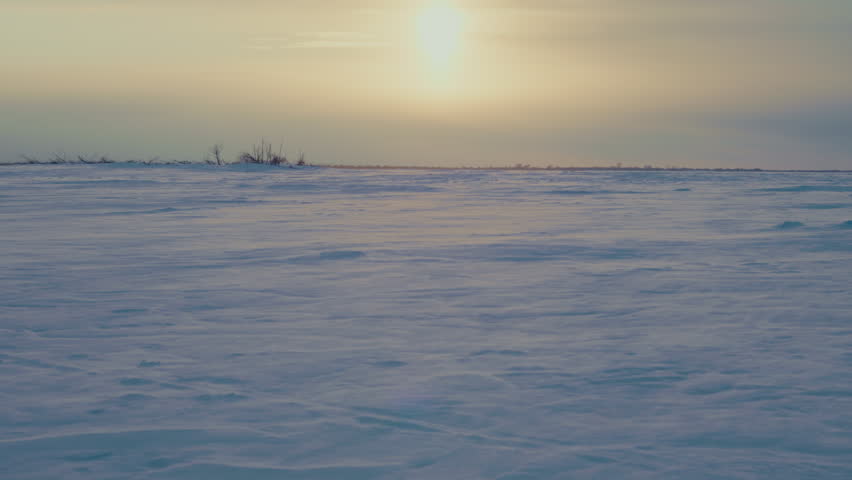 Snow covered frozen river stretching across a remote Russian landscape