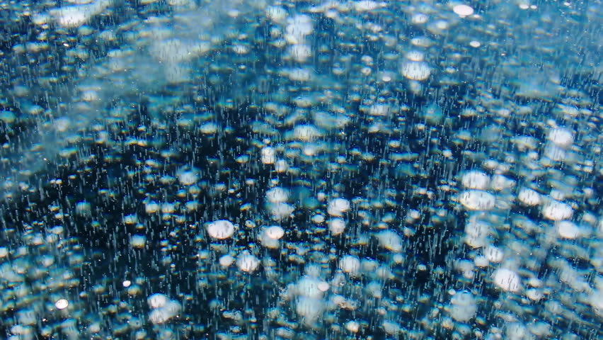 Methane bubbles trapped under thick blue lake ice background. Natural phenomenon gas frozen in cold winter water surface. Beautiful texture of arctic landscape, ecological climate change concept.