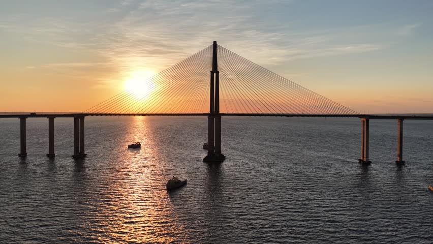 Amazonian Sunset At Manaus In Amazonas Brazil. Sunset Bridge. Boat Sailing. Amazon Black River. Amazonian Sunset In Manaus In Amazonas Brazil. Beautiful Sunset Skyline. Amazon Rainforest.