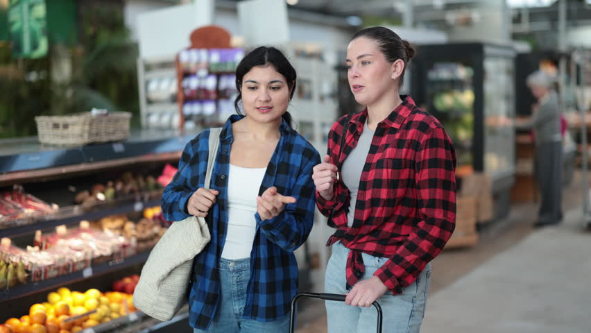 Family shopping at supermarket - choosing something in grocery section of supermarket. High quality 4k footage