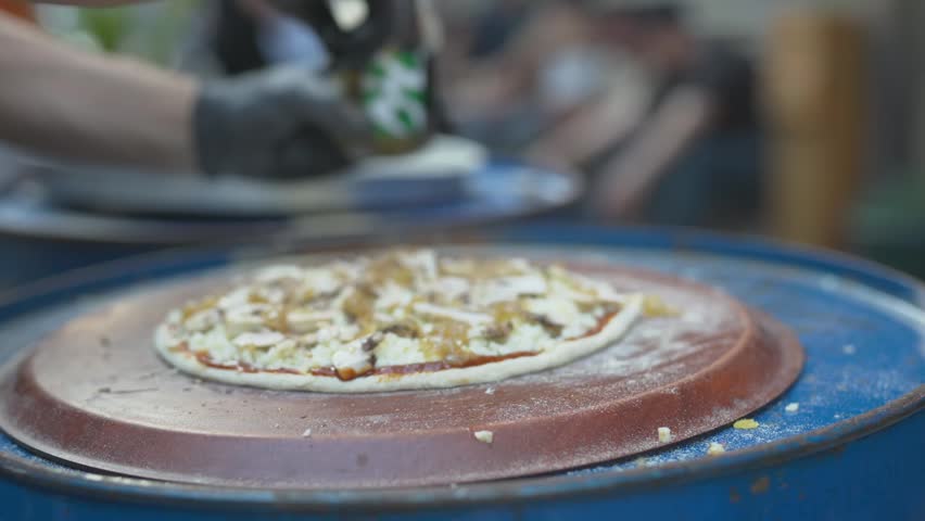 Authentic Italian Margherita pizza served on a rustic outdoor terrace table