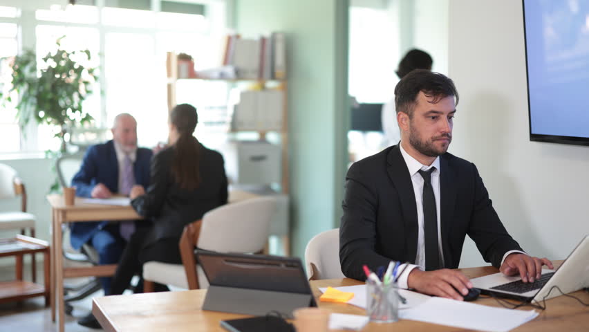Business adult man concentrating on tasks while working at computer in office 