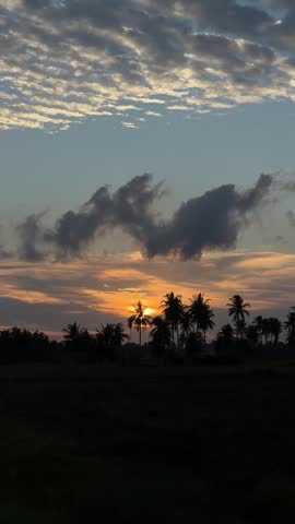 Description:
Dramatic sunset landscape with glowing orange light, dark clouds, and silhouetted trees creating a peaceful atmospheric scene.