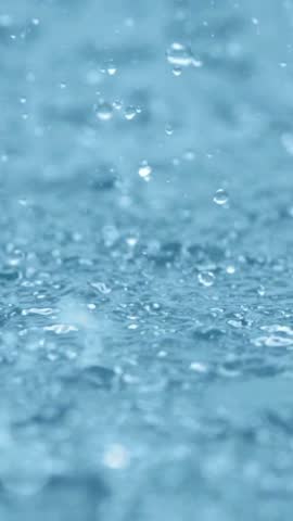 Falling Water Droplets Creating Blue Abstract Background - Dynamic water droplets with a cool blue appearance, suitable for water, rain, freshness, abstract background, and environmental concepts.