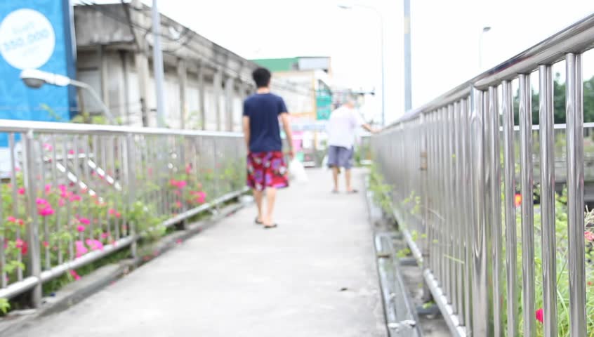 people walking across the bridge above the junction  for safety walking