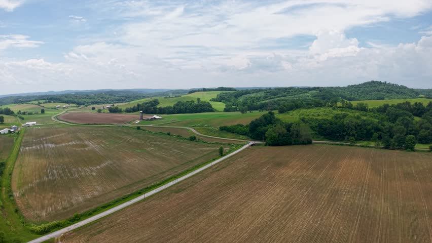 Freshly tilled fields and a narrow farm lane extend across the rural Ohio landscape