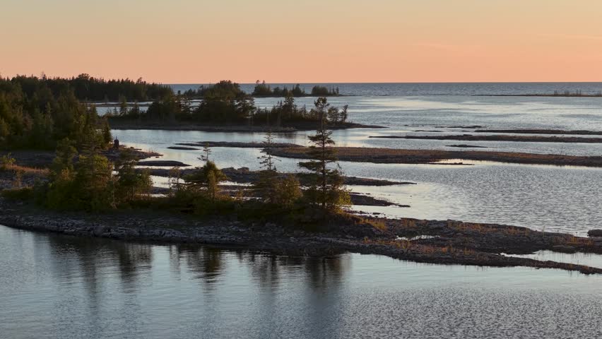 Aerial sunset view overlooks rocky islands and sheltered waters along the Lake Huron shoreline near Tobermory