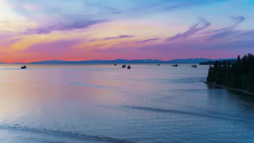 A breathtaking cinematic twilight timelapse capturing a massive industrial cargo freighter navigating the calm, reflective waters of Vancouver Harbor as city lights ignite at dusk.