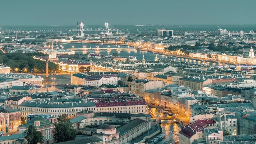 Aerial evening view of Saint Petersburg, Russia, featuring illuminated historic buildings, urban architecture, dramatic lightning, and atmospheric skies. A cinematic cityscape showcasing the distinctive character of the city at dusk.