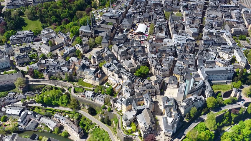 Aerial drone view of the old city of Luxembourg, with the towers of the Notre Dame Cathedral, Place Guillaume II and the Grand Ducal Palace. Panorama of the architecture of the medieval city.