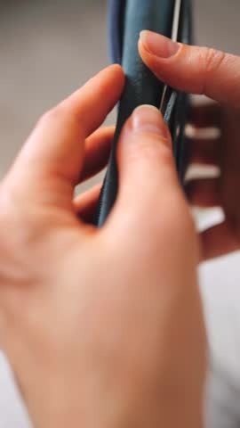 A closeup view of cash being stored in a blue wallet for financial purposes.