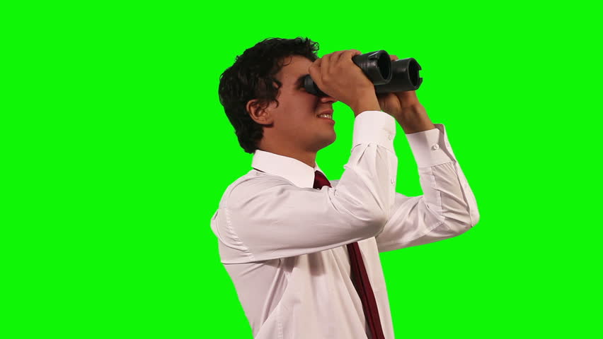 businessman looking through binoculars on green screen