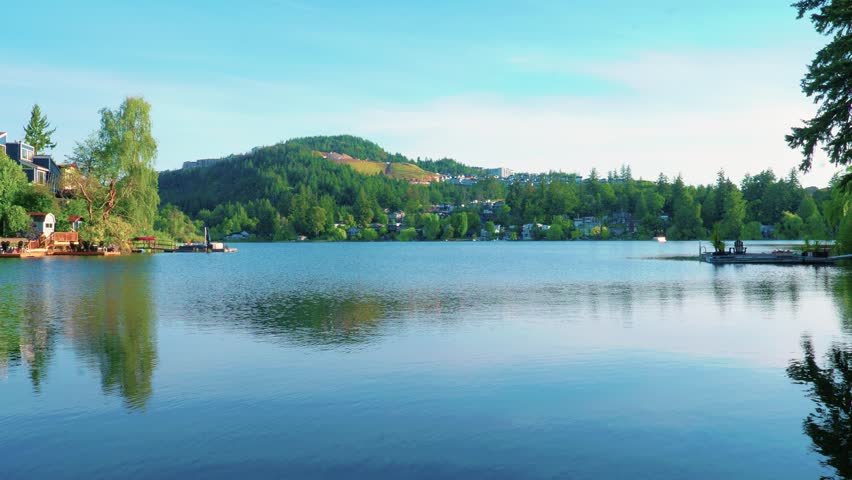 Tranquil Langford Lake landscape in British Columbia reflecting forested hills and lakeside homes