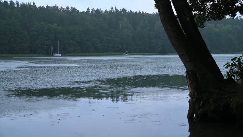 Poland, Masurian Lakes, lake water surface, rain falling, water droplets, twilight