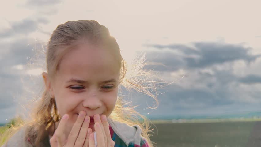 Happy girl close-up, Joyful in nature, Beautiful lighting, Wind-blown hair, Smiling broadly, Peaceful outdoors, Sunny day, Laughter filled, Bright energetic child, Glowing happiness, Lovely girl in