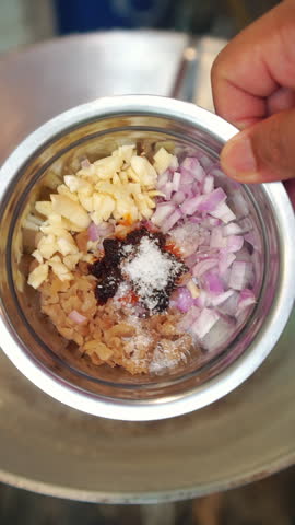 Cooking traditional Thai Pad Thai with fresh prawns. Sauteing minced garlic, shallots, and preserved radish, scrambling an egg, adding rice noodles with tamarind sauce, bean sprouts, garlic chives, fried tofu, dried shrimp, and fresh prawns, toss-frying over high heat in a wok.
