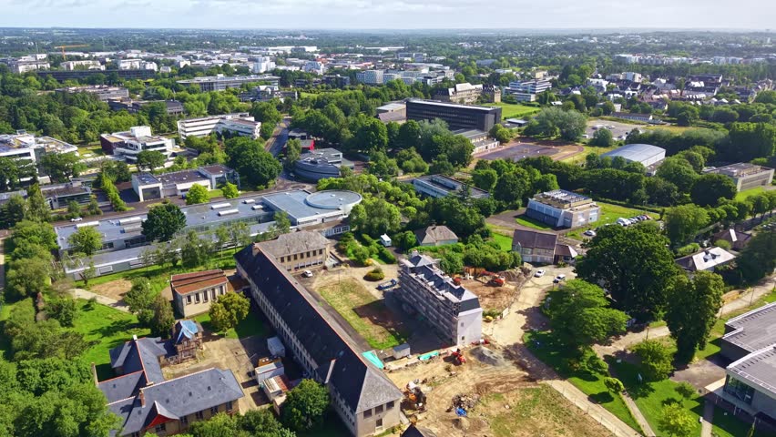 Elevated drone shot of distant Rennes cityscape with Pontchaillou neighborhood in foreground, Ille-et-Vilaine, France