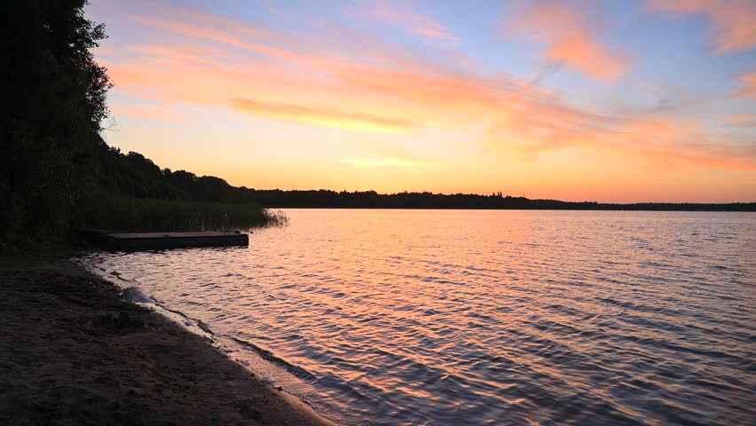 Sunrise over the lake, sandy beach, forest, sunrise sky