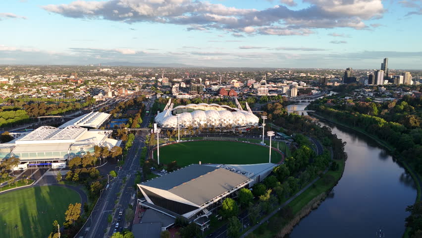Aerial view of Melbourne Olympic Park and the Yarra River, featuring major sports venues, stadiums, parkland and the surrounding urban landscape in Melbourne, Australia.