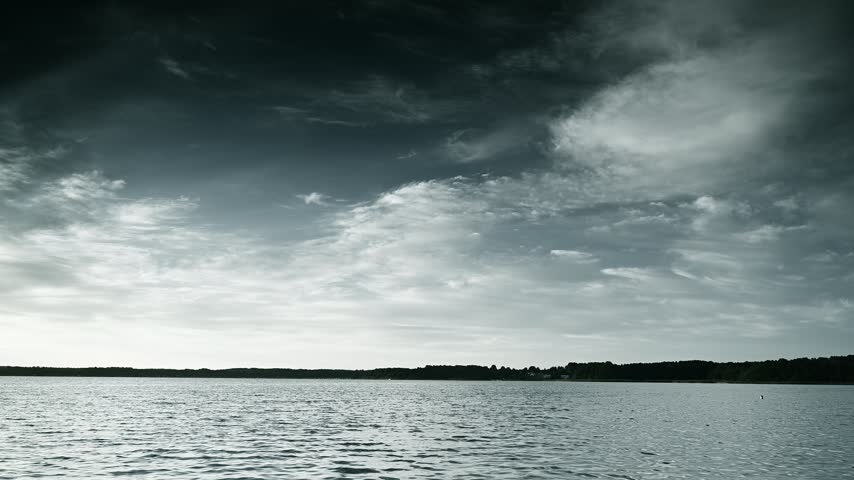 Dramatic sky above the horizon, lake surface, black and white