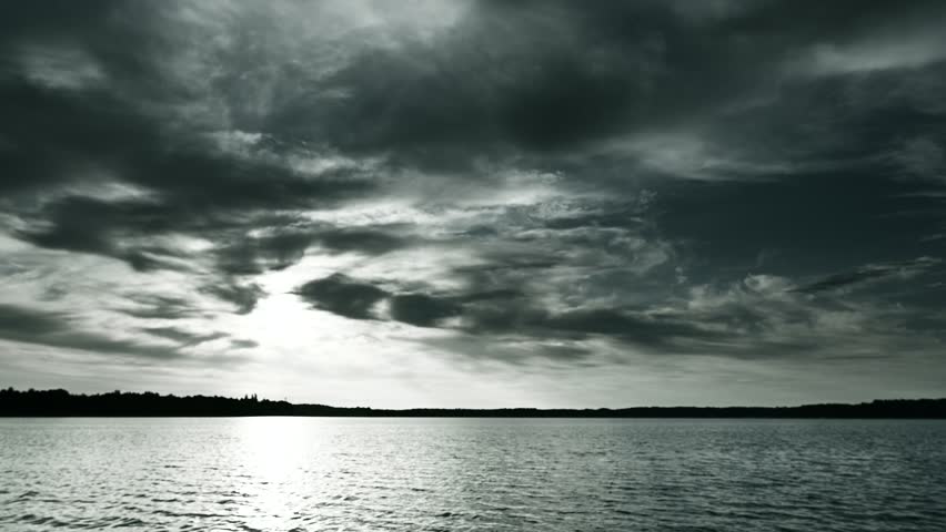 Dramatic sky above the horizon, lake surface, black and white