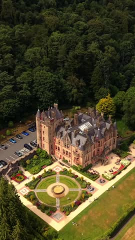 Rising 60FPS vertical social ratio aerial video of Belfast Castle and Cavehill in North Belfast, Northern Ireland in the UK on a bright sunny day. Produced with Rec709 colour.