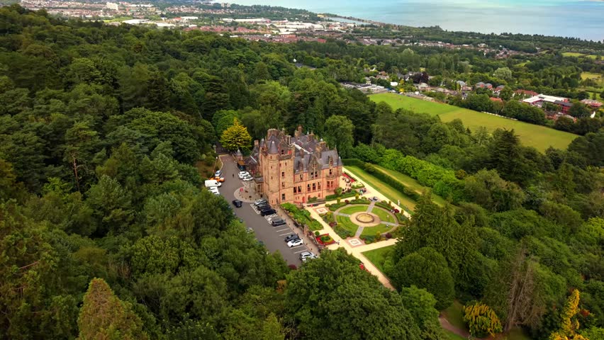Anti-clockwise 4K 60FPS aerial video of Belfast Castle and Cavehill in North Belfast, Northern Ireland in the UK on a bright sunny day. Produced with Rec709 colour.