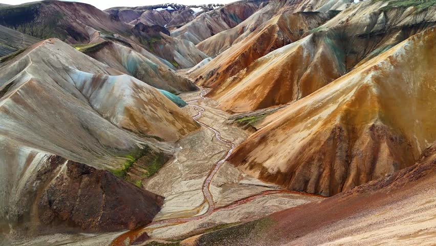 Drone shot over Landmannalaugar rainbow mountains valley on a sunny summer day, Laugavegur hiking trail, volcanic landscape, Iceland