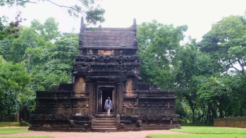 Tourist entering ancient stone temple Nalanda Gedige in Sri Lanka