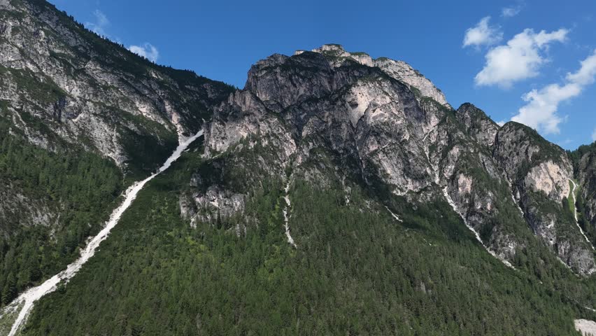 serene mountain landscape with rocky terrain and lush greenery from an aerial perspective in nature setting, travel and photography backgrounds with vibrant blue skies and green.