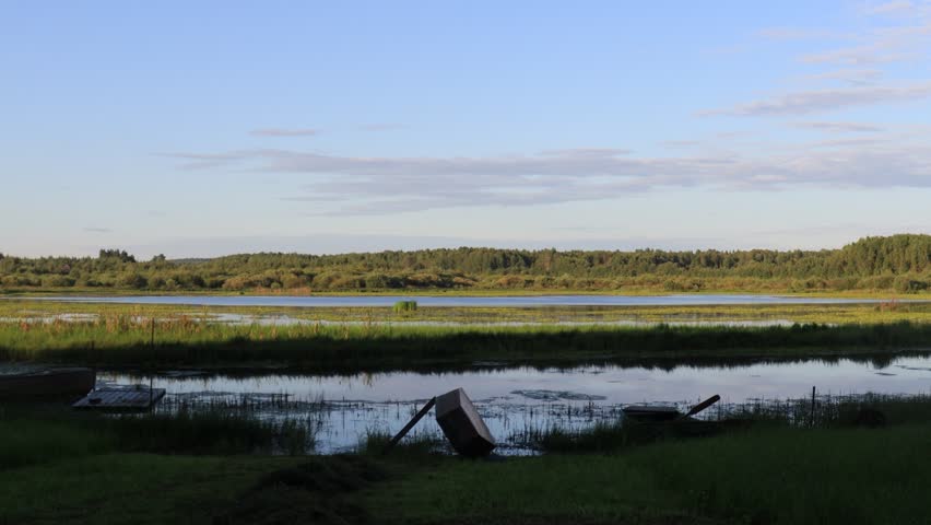 boats on the lake shore on a sunny summer evening
