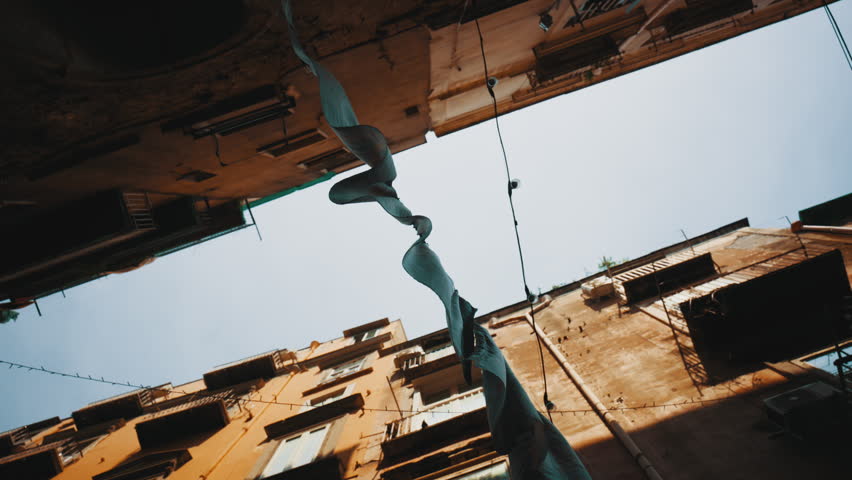 Laundry hanging between buildings in Naples, on a typical street in the center